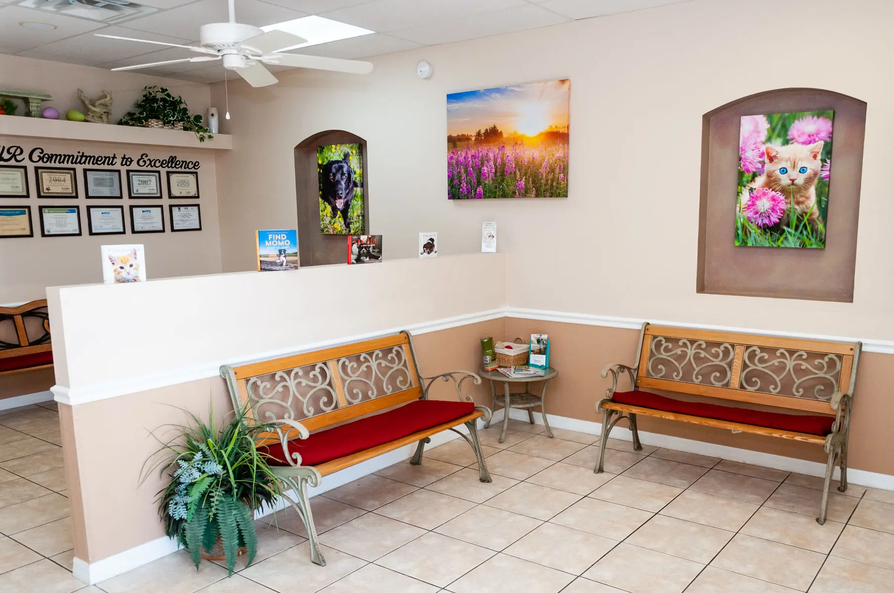 A couple of benches in a room with pictures on the wall.